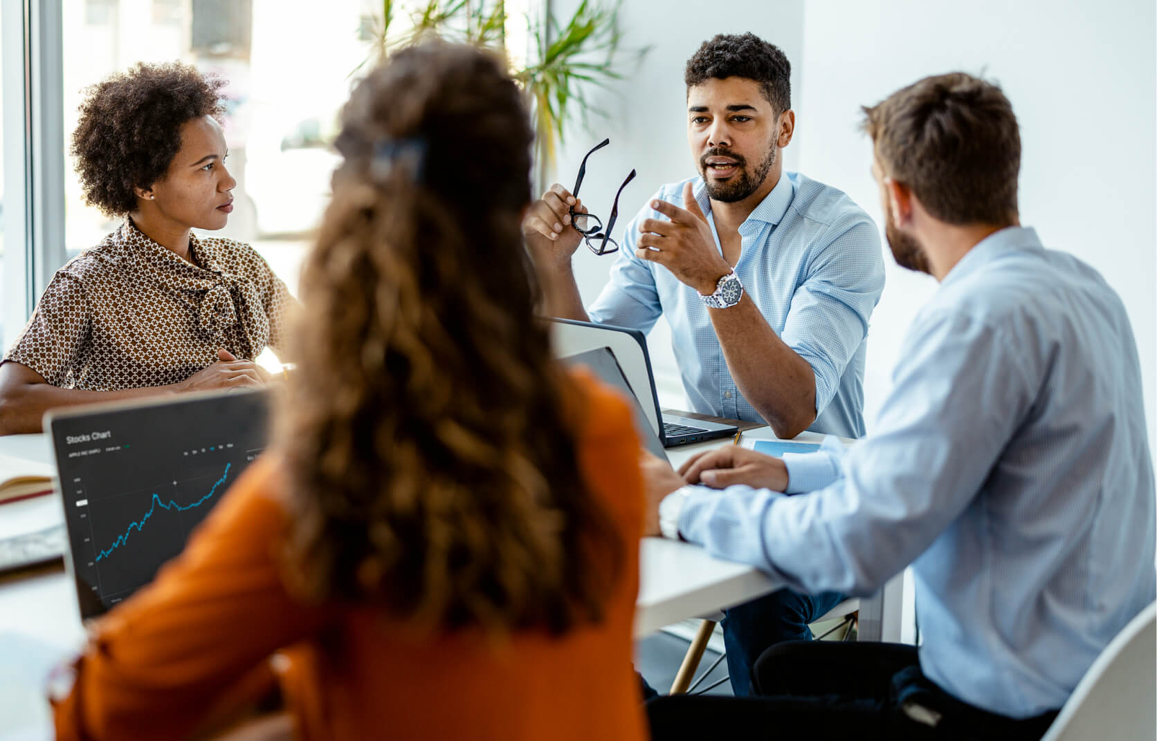 A team of cybersecurity professionals discussing cybersecurity staffing at a conference table